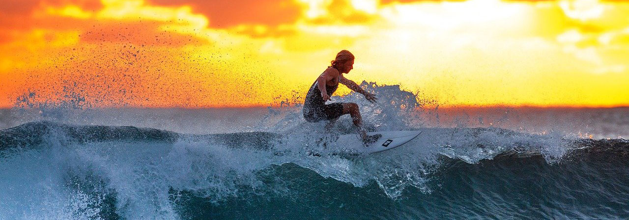 person surfing at sunset
